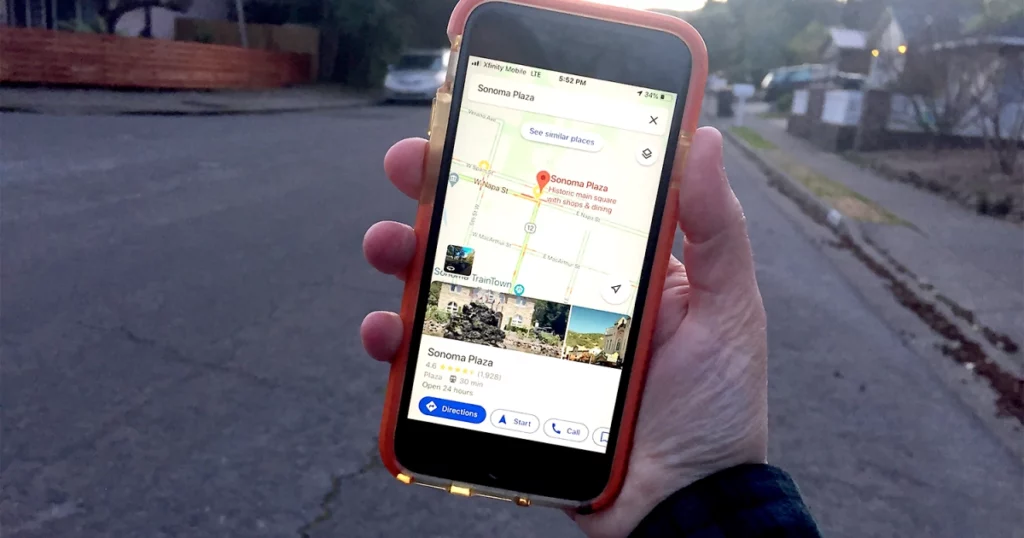 Hand holding phone with Google Maps
