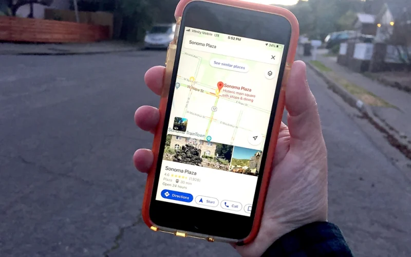 Hand holding phone with Google Maps
